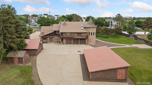 11485 Pecos St, Denver, CO 80234 - rear view of property with driveway, an attached garage, an outdoor structure, a residential view, and a balcony