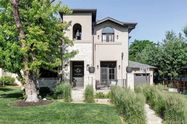 3255 S Birch St, Denver, CO 80222 - view of front of home featuring stone siding, an attached garage, stucco siding, and a front lawn