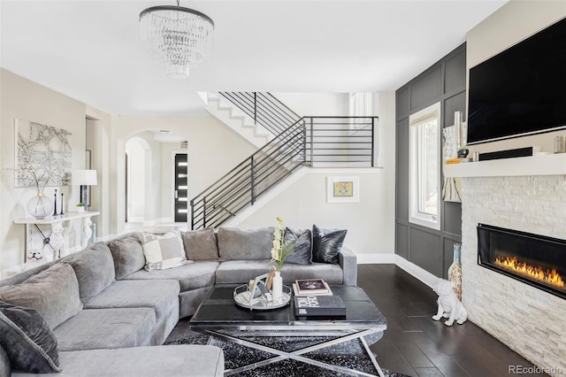 3255 S Birch St, Denver, CO 80222 - living room with stairs, dark wood-style flooring, arched walkways, and a fireplace