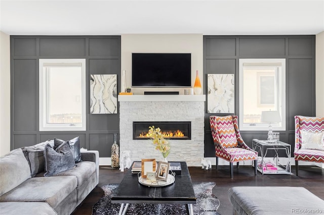 3255 S Birch St, Denver, CO 80222 - living room featuring a decorative wall, plenty of natural light, a stone fireplace, and wood finished floors