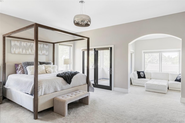 3255 S Birch St, Denver, CO 80222 - carpeted bedroom with arched walkways, multiple windows, and access to exterior