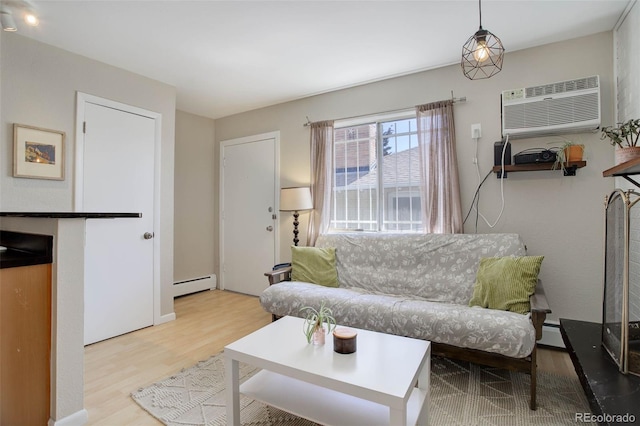 living room featuring a baseboard radiator, wood finished floors, and an AC wall unit