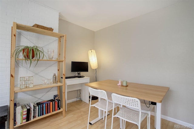 office area featuring baseboards and wood finished floors