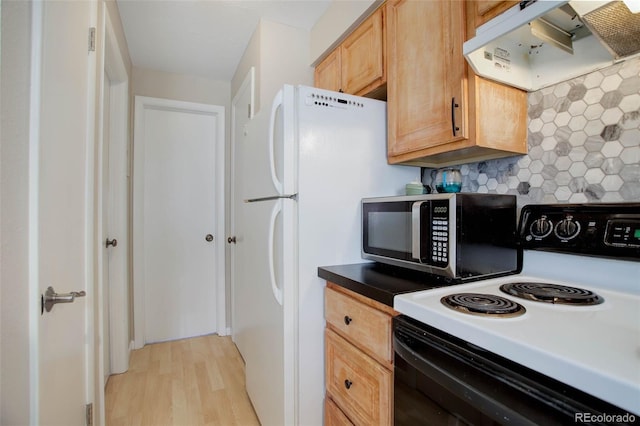 kitchen with tasteful backsplash, range with electric cooktop, light wood-style flooring, stainless steel microwave, and under cabinet range hood