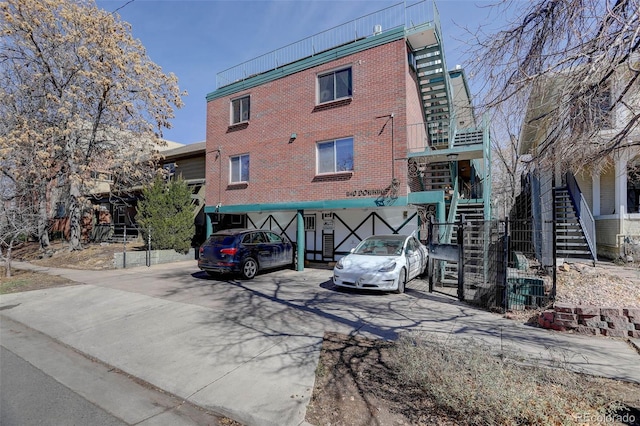 view of front of house featuring brick siding and stairs