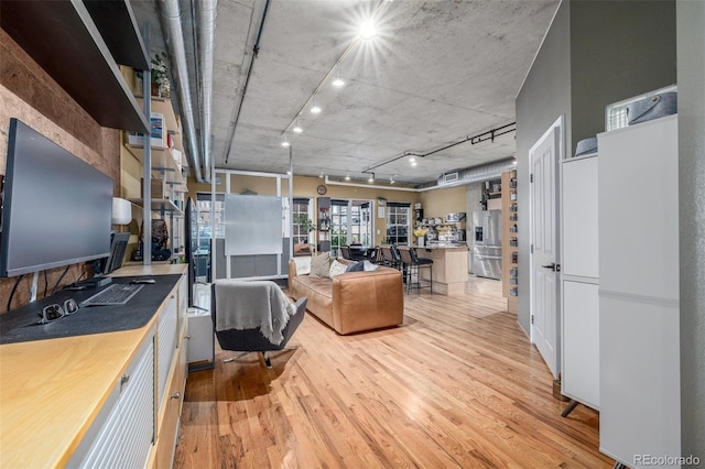 1499 Blake St Unit 4F, Denver, CO 80202 - living room featuring light wood-style floors and rail lighting