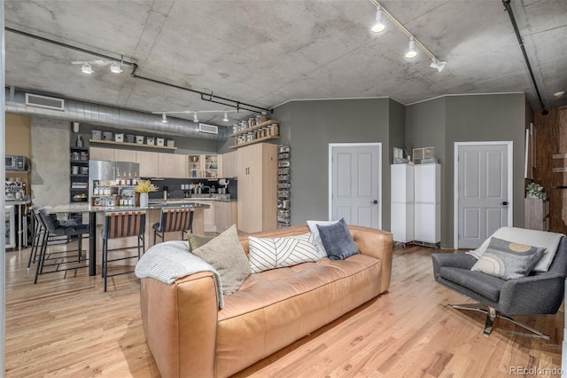 1499 Blake St Unit 4F, Denver, CO 80202 - living room featuring track lighting and light wood-style floors