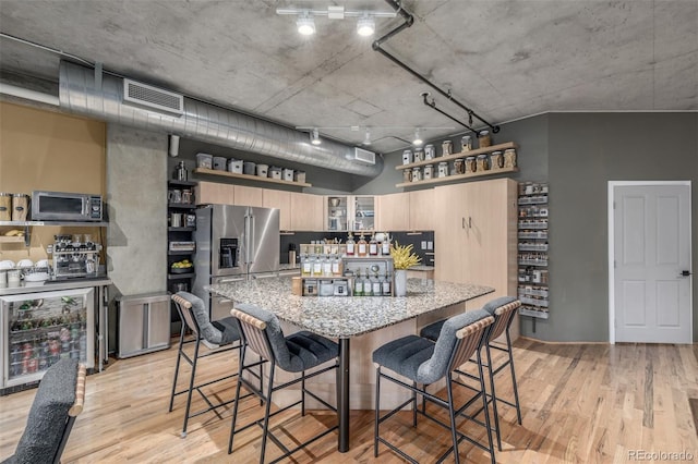 1499 Blake St Unit 4F, Denver, CO 80202 - kitchen with wine cooler, open shelves, stainless steel appliances, and light wood-type flooring