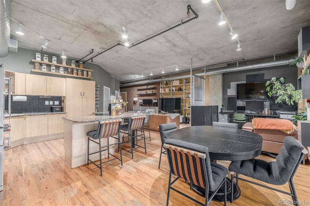 1499 Blake St Unit 4F, Denver, CO 80202 - dining room featuring light wood-style floors and track lighting