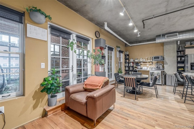 1499 Blake St Unit 4F, Denver, CO 80202 - sunroom / solarium with rail lighting, french doors, healthy amount of natural light, and beverage cooler