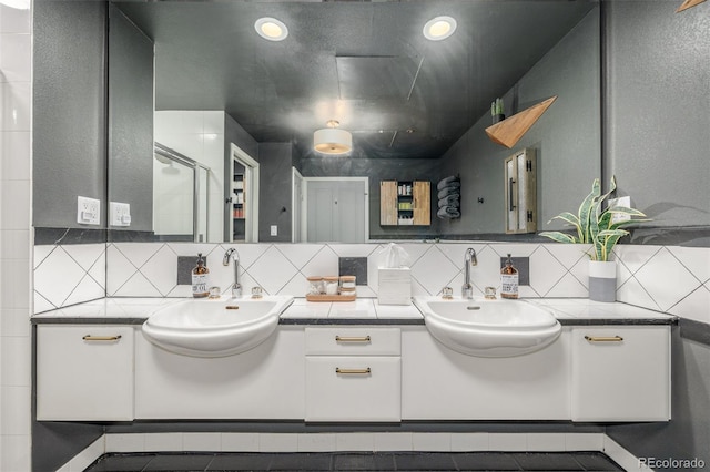 1499 Blake St Unit 4F, Denver, CO 80202 - full bath with double vanity, backsplash, and a shower with door