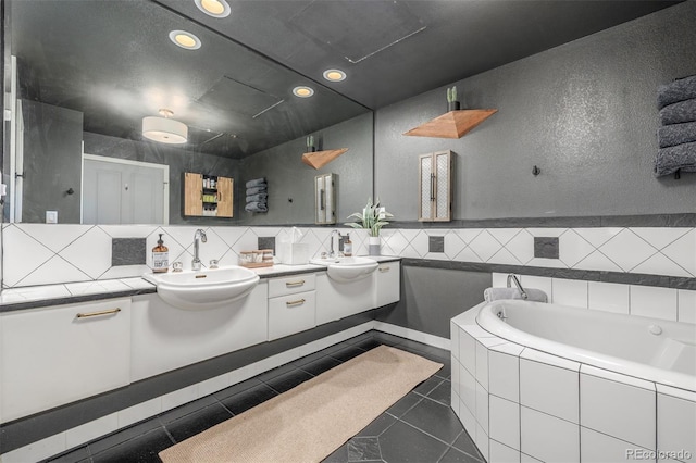 1499 Blake St Unit 4F, Denver, CO 80202 - bathroom featuring recessed lighting, double vanity, a garden tub, tile patterned flooring, and decorative backsplash