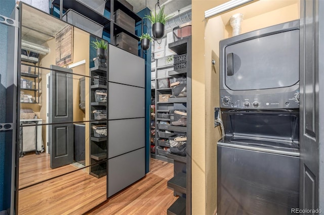 1499 Blake St Unit 4F, Denver, CO 80202 - laundry area with stacked washer / drying machine and wood finished floors