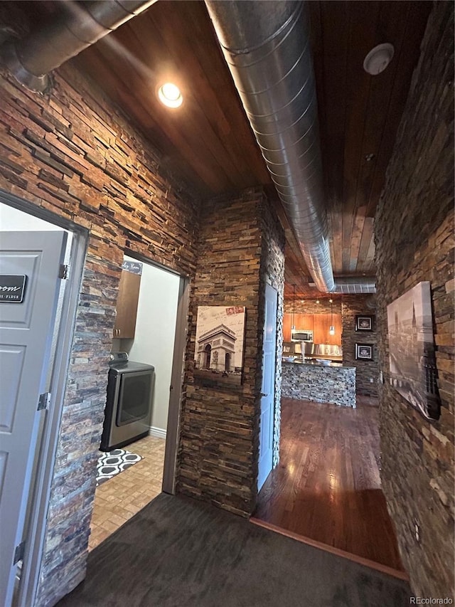 corridor featuring hardwood / wood-style flooring, washer / dryer, and wood ceiling