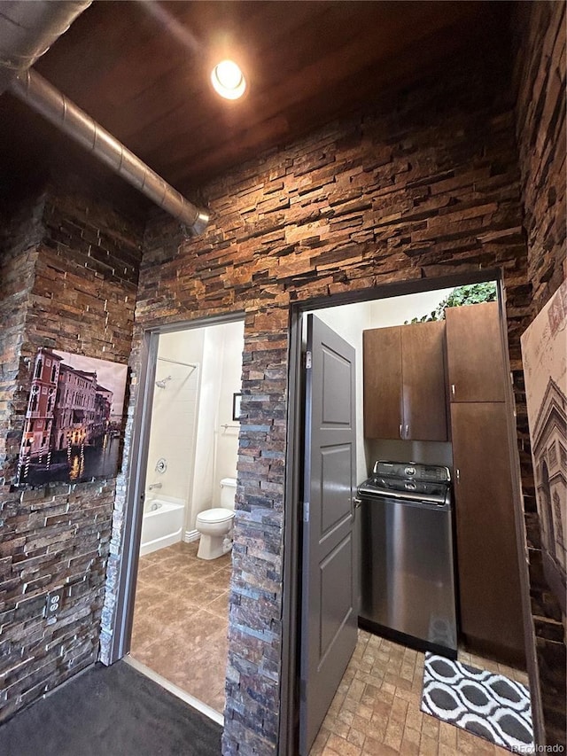 interior space with toilet and washer / clothes dryer