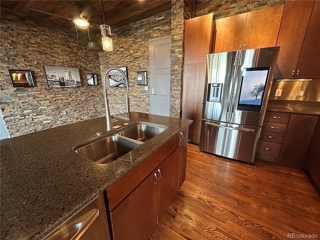 kitchen featuring sink, wood ceiling, dark stone countertops, dark hardwood / wood-style floors, and stainless steel refrigerator with ice dispenser