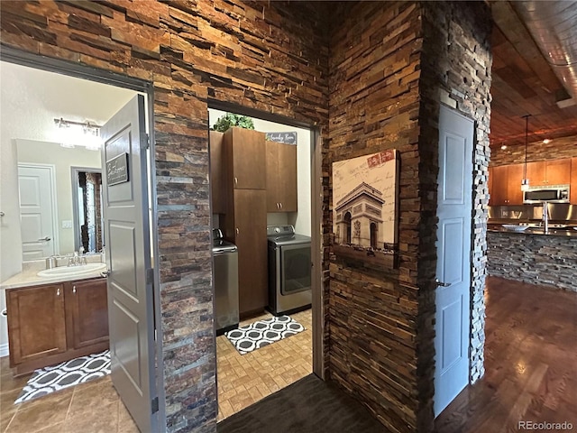 interior space featuring vanity, washer / clothes dryer, and wooden ceiling