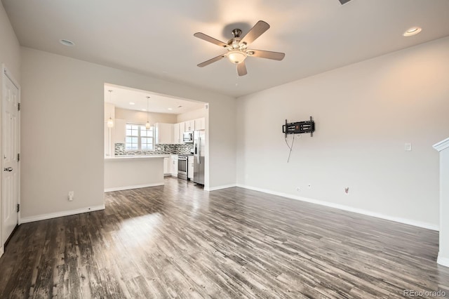 unfurnished living room with dark wood-style floors, recessed lighting, ceiling fan, and baseboards