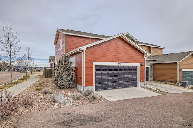 traditional-style home featuring a garage and fence