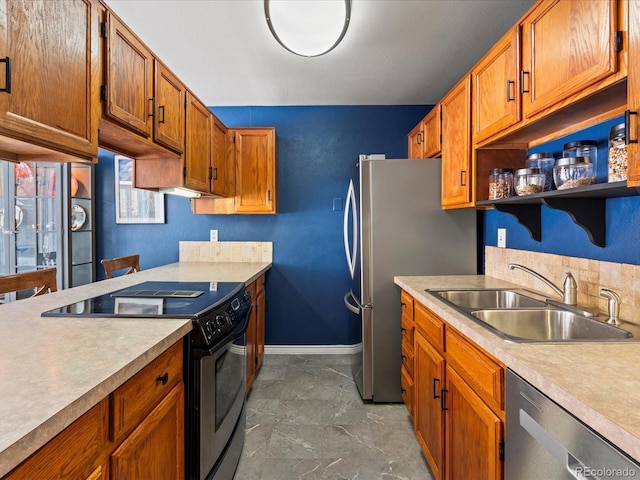 kitchen with light countertops, a sink, electric range, and stainless steel dishwasher