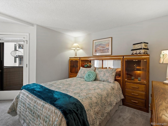 bedroom with carpet and a textured ceiling