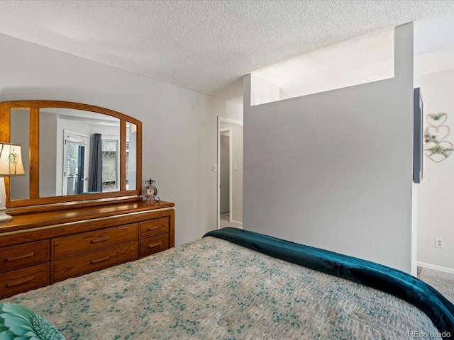 bedroom featuring carpet floors and a textured ceiling