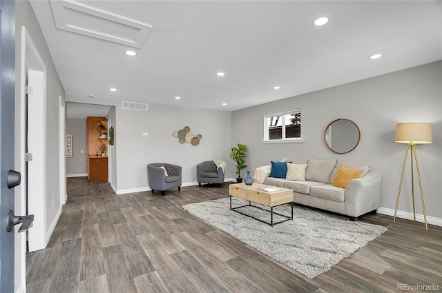 living room with wood finished floors, visible vents, and recessed lighting