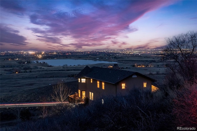 11730 Pointe View Dr, Longmont, CO 80503 - property exterior at dusk featuring stucco siding and a water view