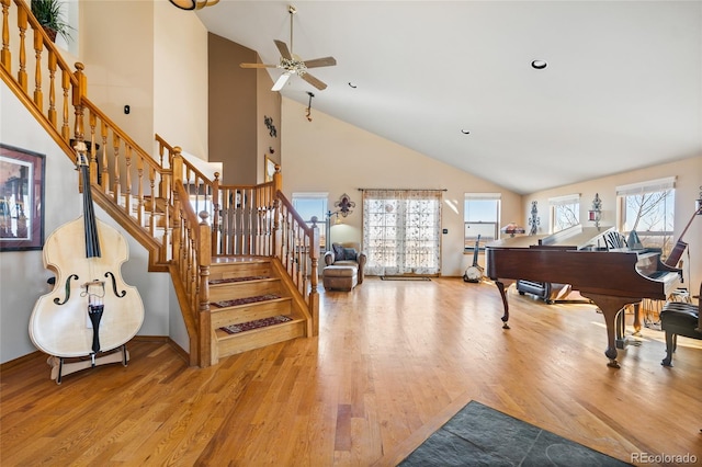 11730 Pointe View Dr, Longmont, CO 80503 - living area featuring light wood-style floors, a ceiling fan, stairs, and high vaulted ceiling