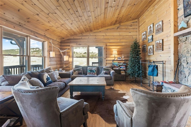 living room with rustic walls, light hardwood / wood-style flooring, lofted ceiling, and wood ceiling