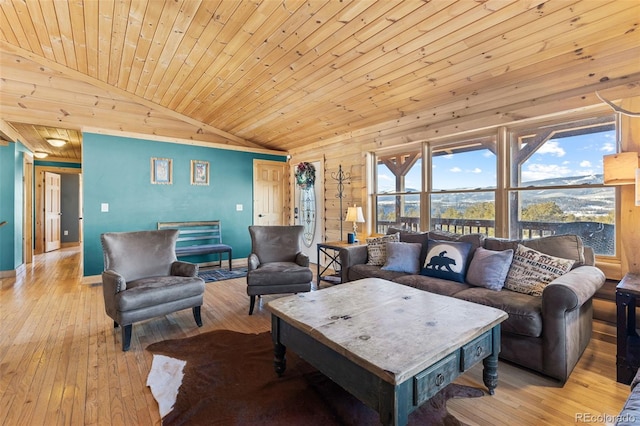 living room featuring light hardwood / wood-style floors, wood ceiling, and vaulted ceiling