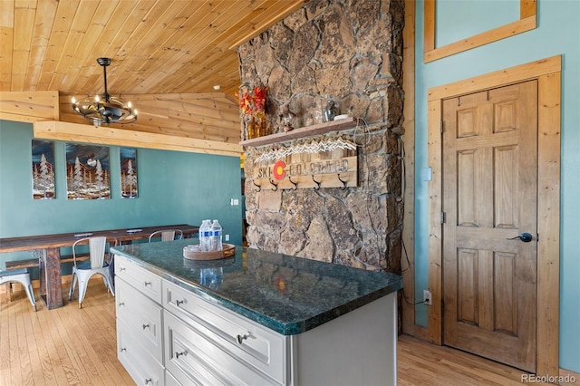 kitchen featuring wooden ceiling, white cabinets, lofted ceiling, and light hardwood / wood-style floors