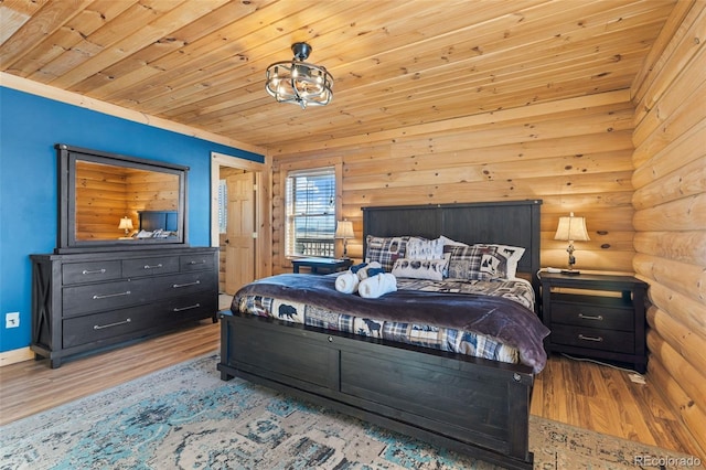 bedroom featuring wooden ceiling, light hardwood / wood-style floors, and rustic walls