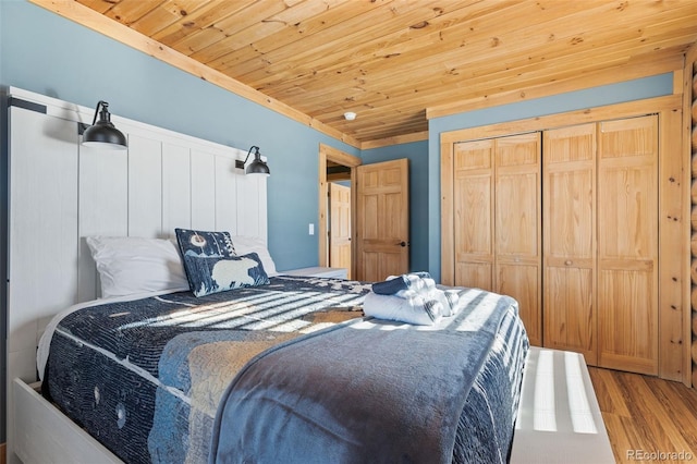 bedroom featuring wood ceiling, hardwood / wood-style flooring, and a closet