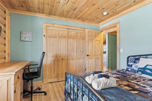 bedroom featuring wooden ceiling, crown molding, light hardwood / wood-style flooring, and a closet