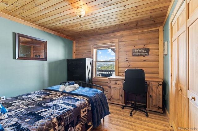 bedroom with crown molding, wooden ceiling, light hardwood / wood-style flooring, and a closet