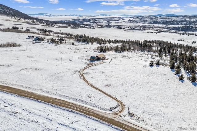 snowy aerial view with a mountain view