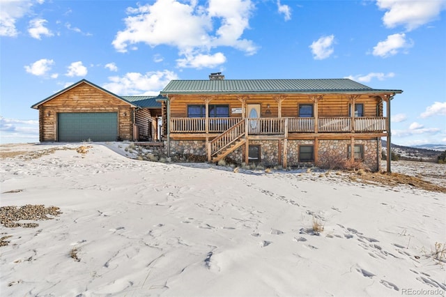 log home featuring a porch and a garage