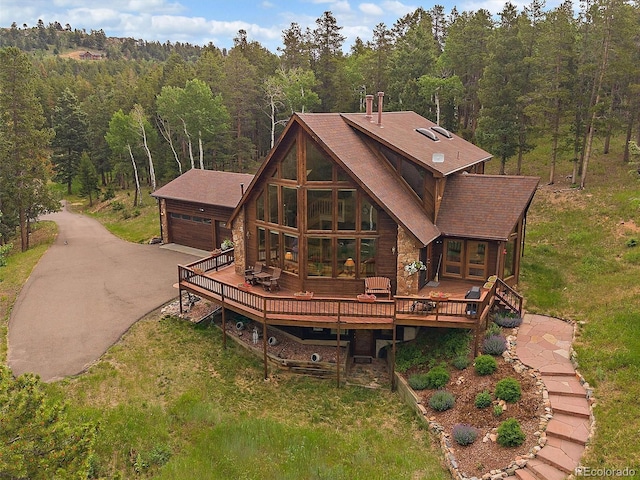 13094 Molly Dr, Conifer, CO 80433 - back of house with a wooded view, a deck, and a detached garage