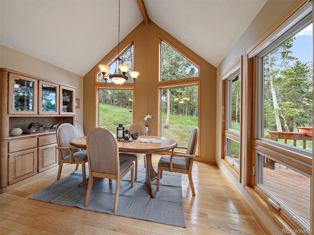 13094 Molly Dr, Conifer, CO 80433 - dining area with a chandelier, beam ceiling, light wood-style floors, and high vaulted ceiling