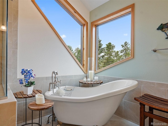 13094 Molly Dr, Conifer, CO 80433 - full bathroom with tile walls, a freestanding bath, and wainscoting