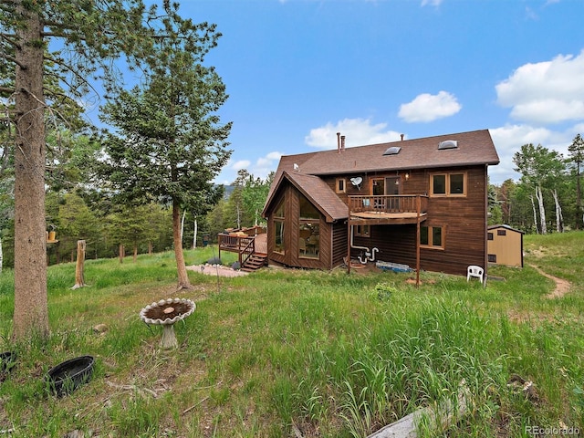13094 Molly Dr, Conifer, CO 80433 - rear view of house with a storage shed and a deck
