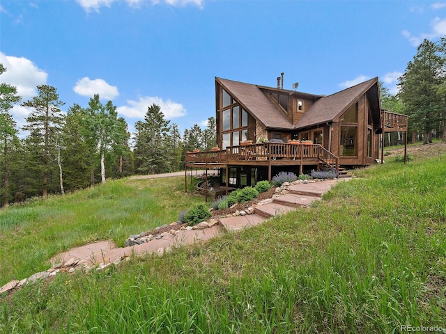13094 Molly Dr, Conifer, CO 80433 - rear view of property with a wooden deck and a sunroom