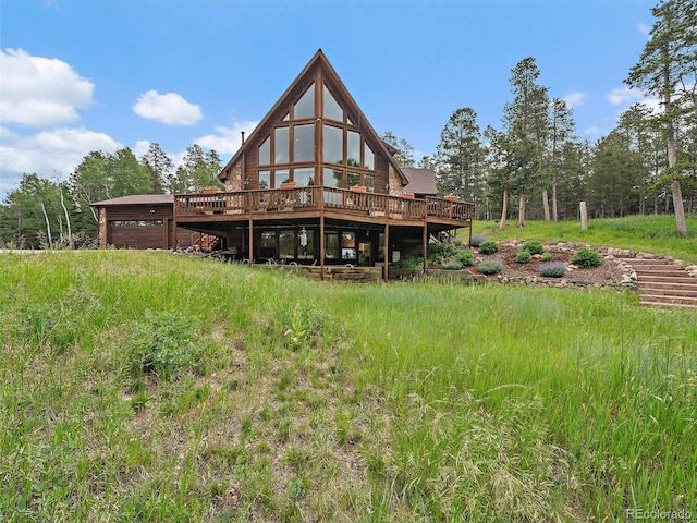 13094 Molly Dr, Conifer, CO 80433 - rear view of house with a wooden deck and a garage