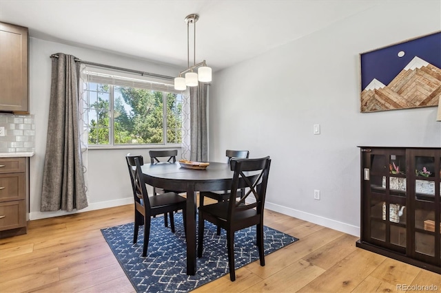 dining room with light wood-style flooring and baseboards