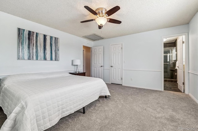 bedroom with a textured ceiling, carpet floors, a ceiling fan, ensuite bath, and baseboards