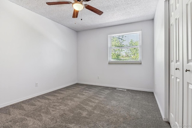 unfurnished bedroom featuring carpet flooring, a textured ceiling, a closet, baseboards, and a ceiling fan
