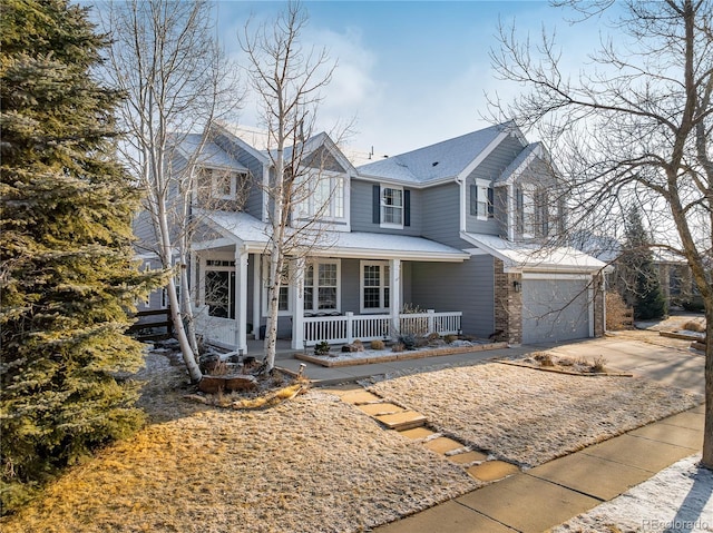 view of front of home featuring a garage, driveway, and a porch