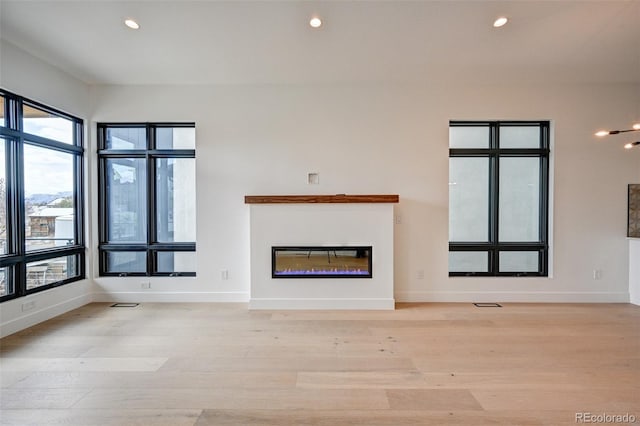 unfurnished living room featuring light hardwood / wood-style floors