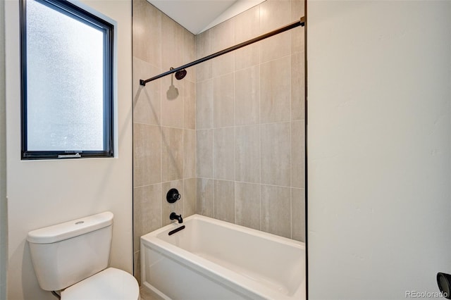 bathroom with plenty of natural light, toilet, and tiled shower / bath